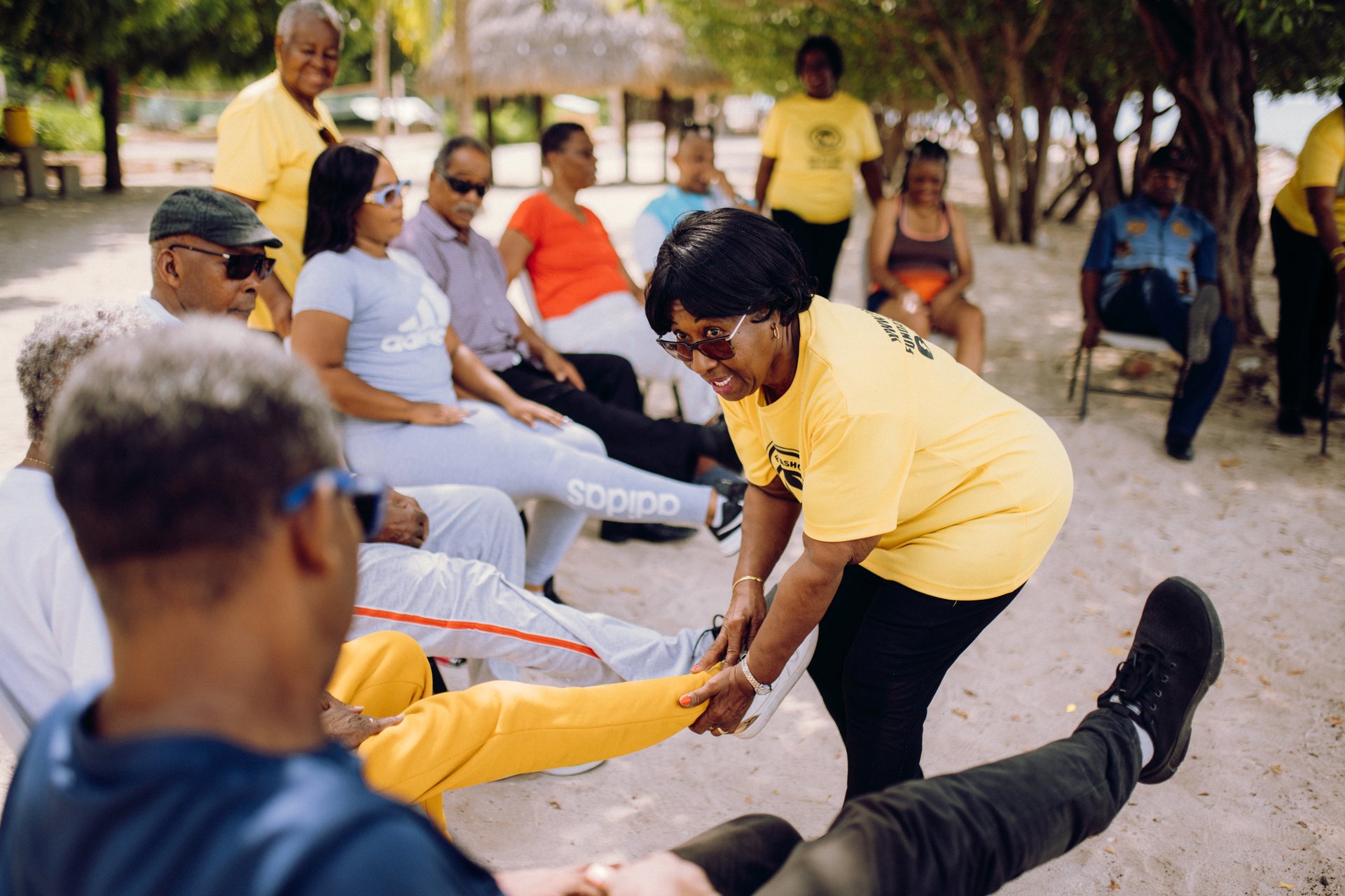 Participants doing exercises together on the ground during an outdoor activity