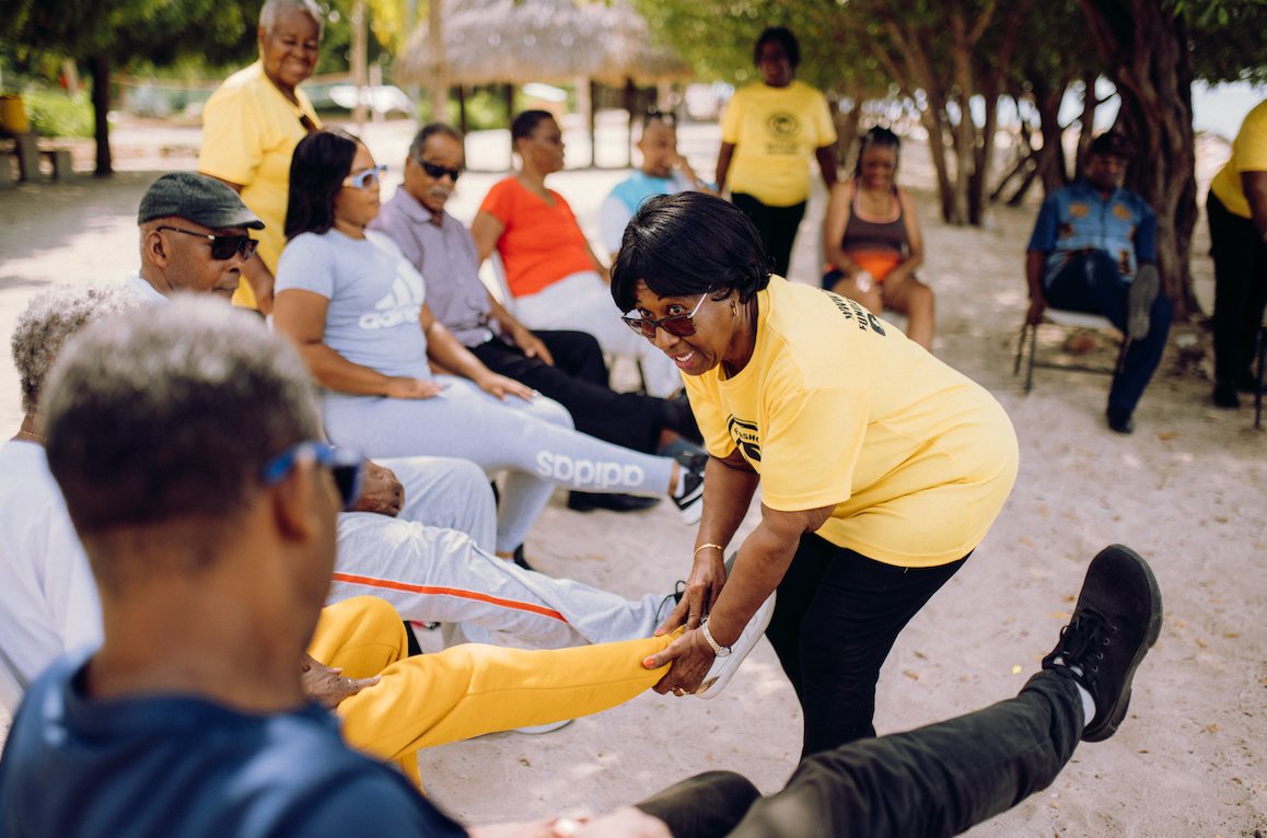 Participants stretching together during an outdoor exercise activity