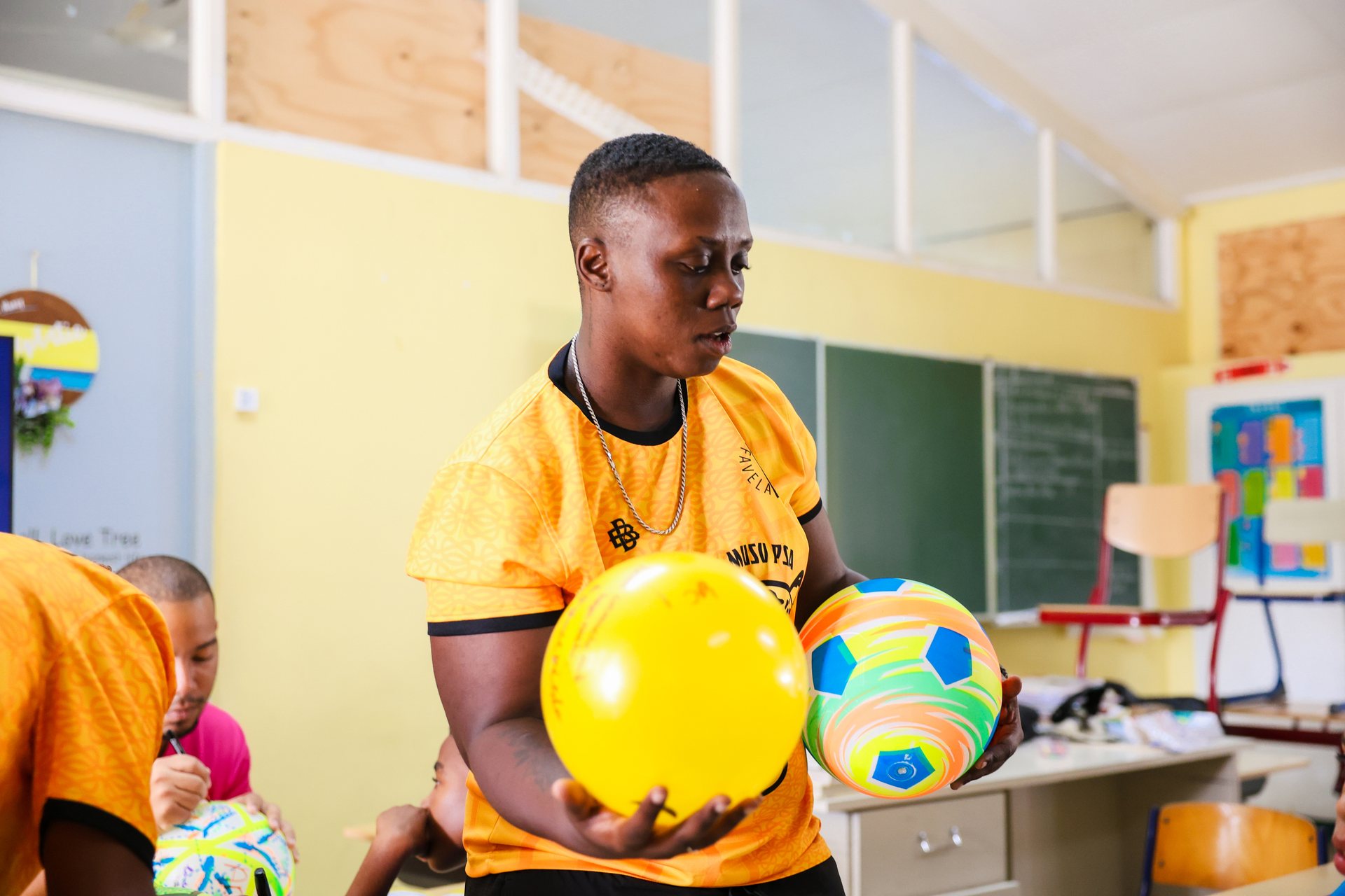 Boy with a ball during a play activity in a colourful classroom