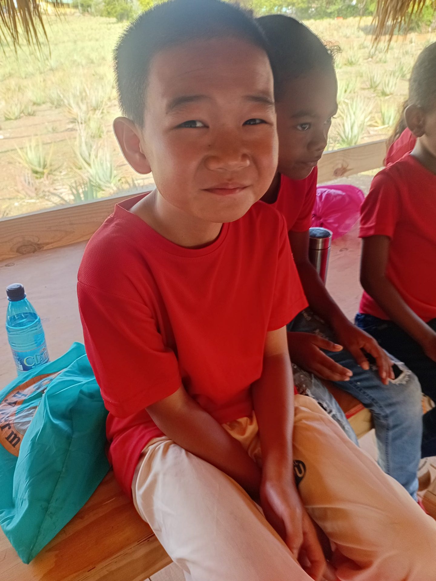Smiling boy sitting on the ground during an activity