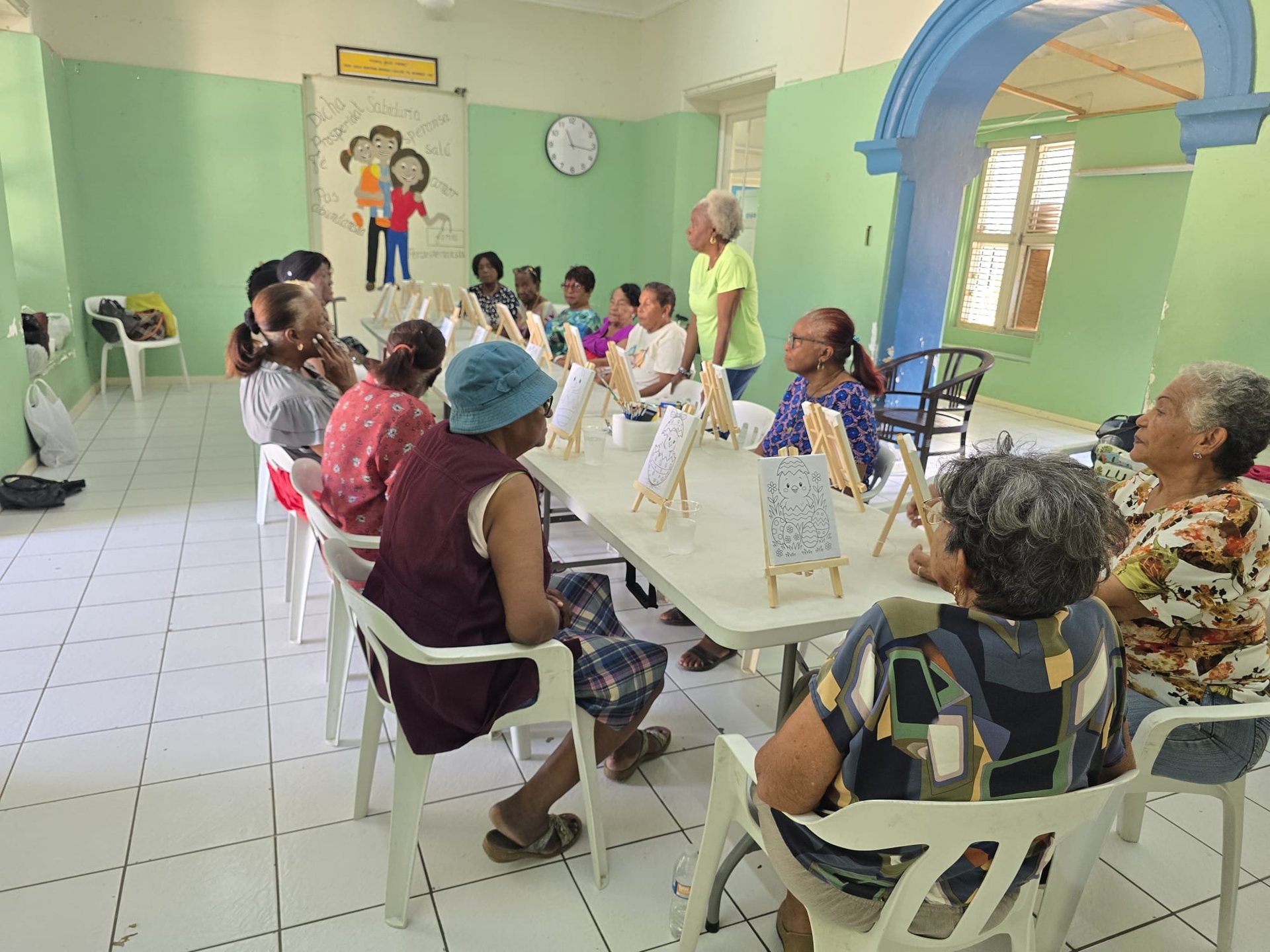 Older people sitting in a circle during an activity in a neighbourhood centre