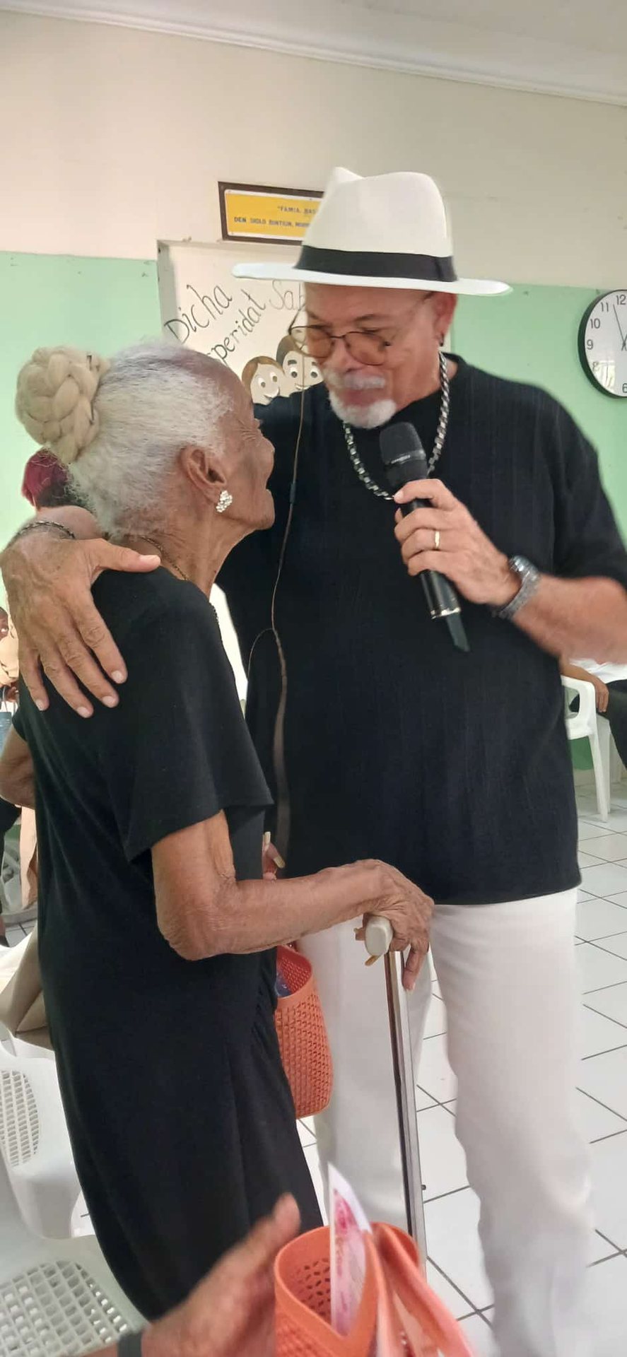 Two people embracing during an outdoor gathering