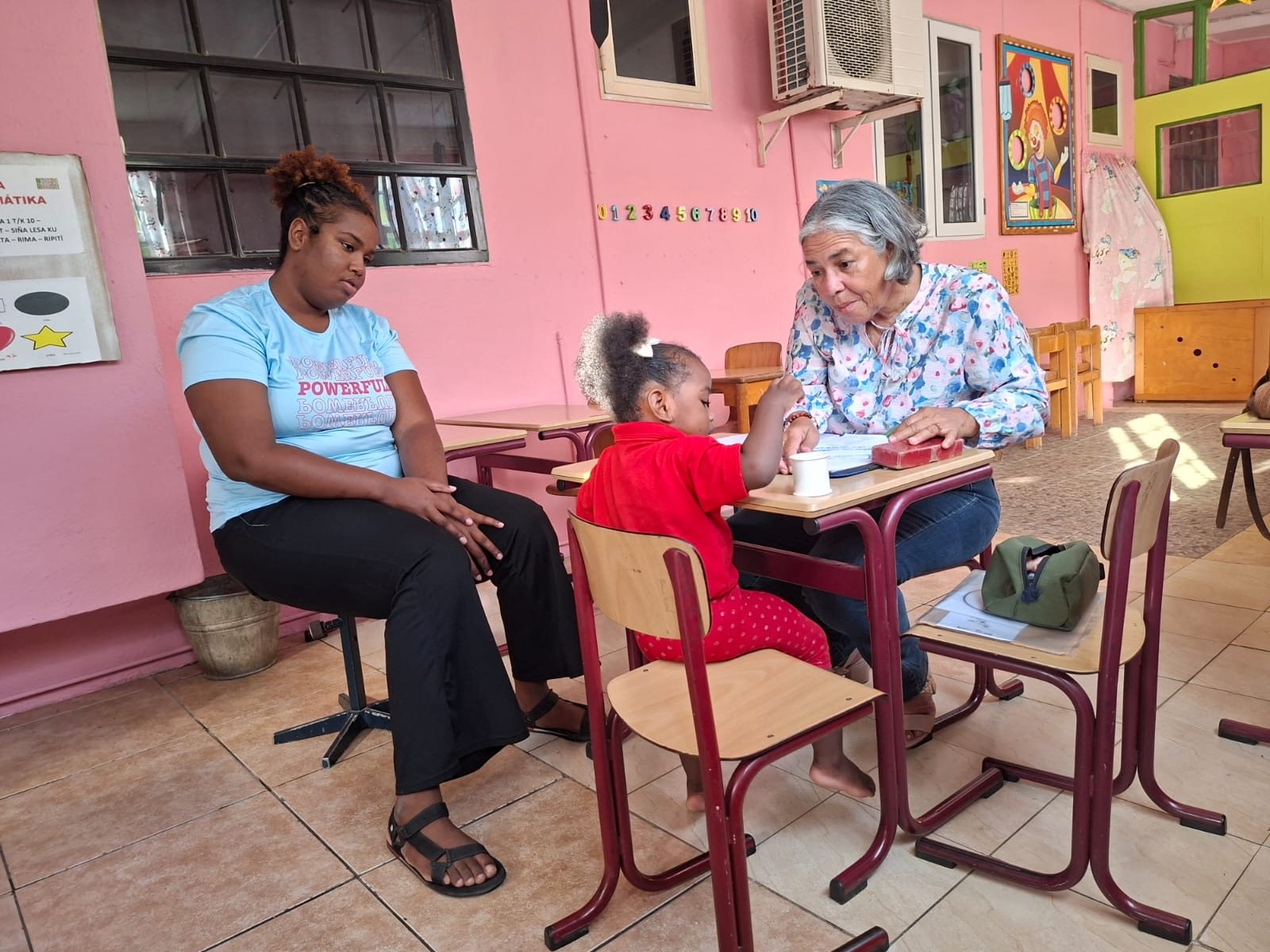 Two women talking at a table in a neighbourhood centre